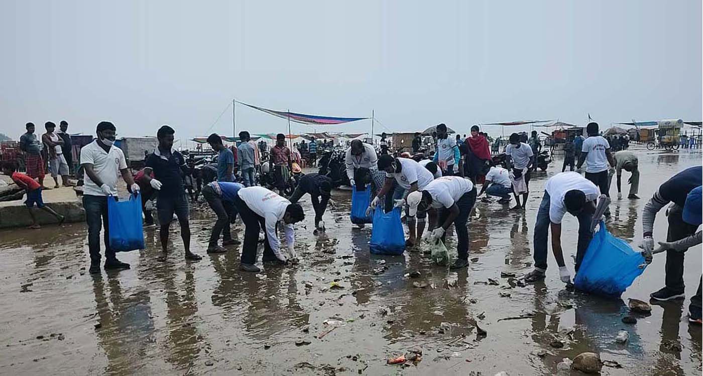 People cleaning a beach area
